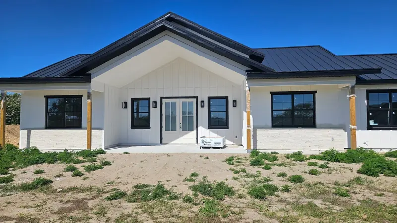 Modern Barnhome custom home with black-framed windows and metal roof in Groveland, Florida